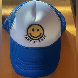 Women’s trucker hat with smiley face and “Take it Easy” on front.